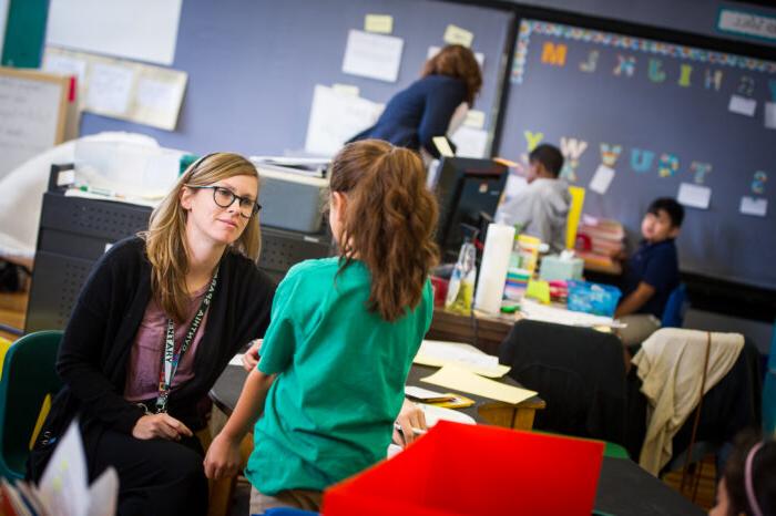 A teacher is listening to her student.