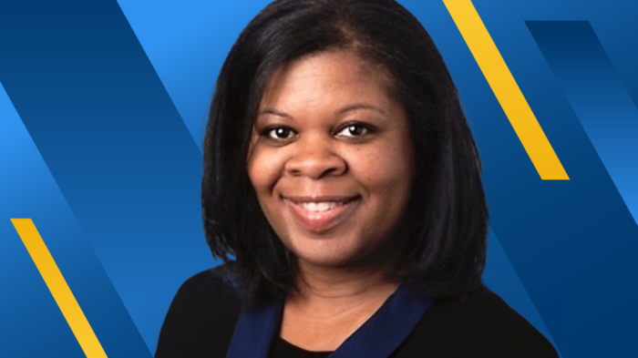 ETAMU alum Sharlene Belton-Gonzalez on a blue- and gold-barred background